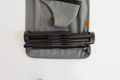 gray fabric seat with collapsed baby chair frame laid across.
